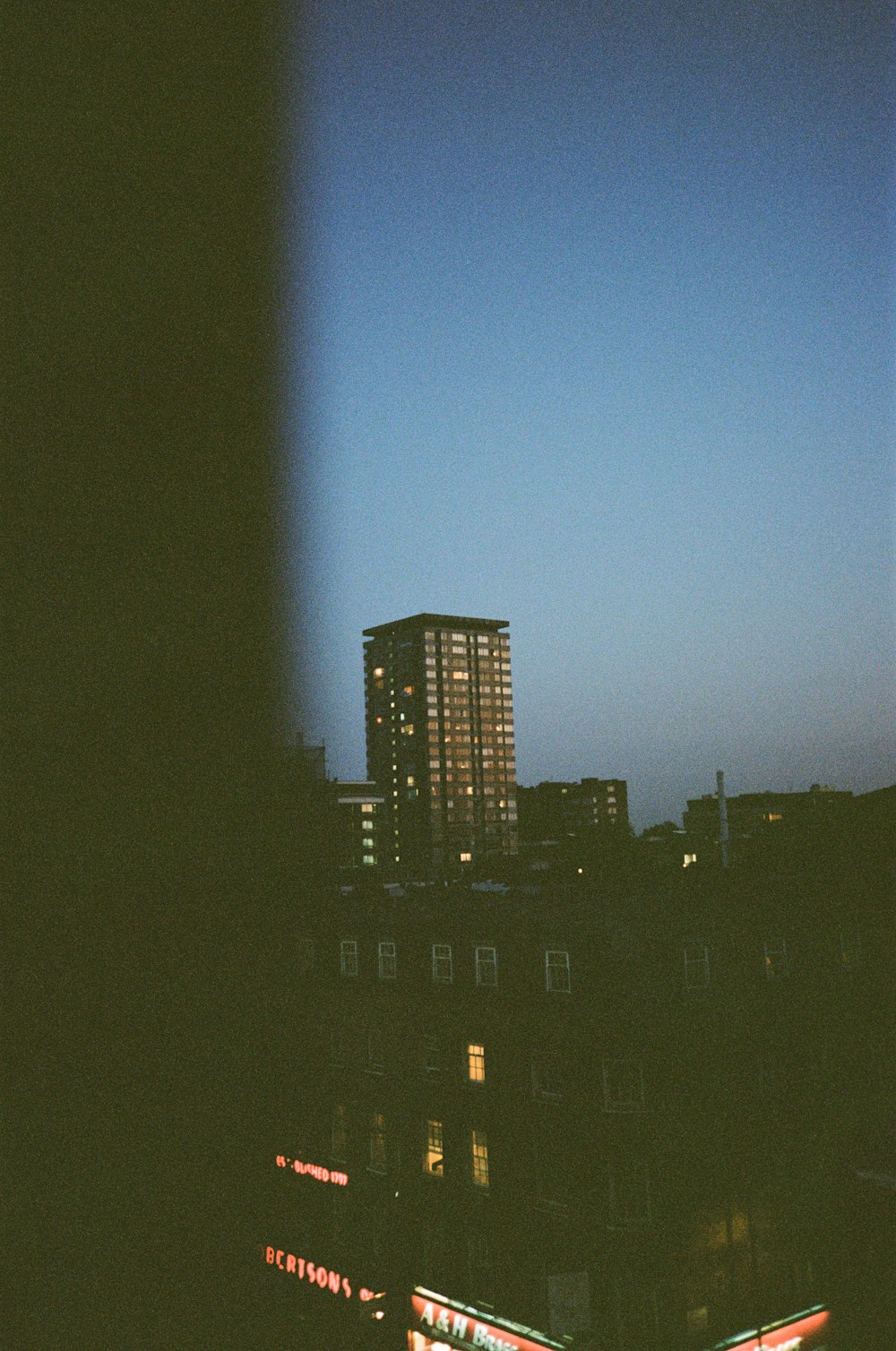 silhouette of city buildings during night time