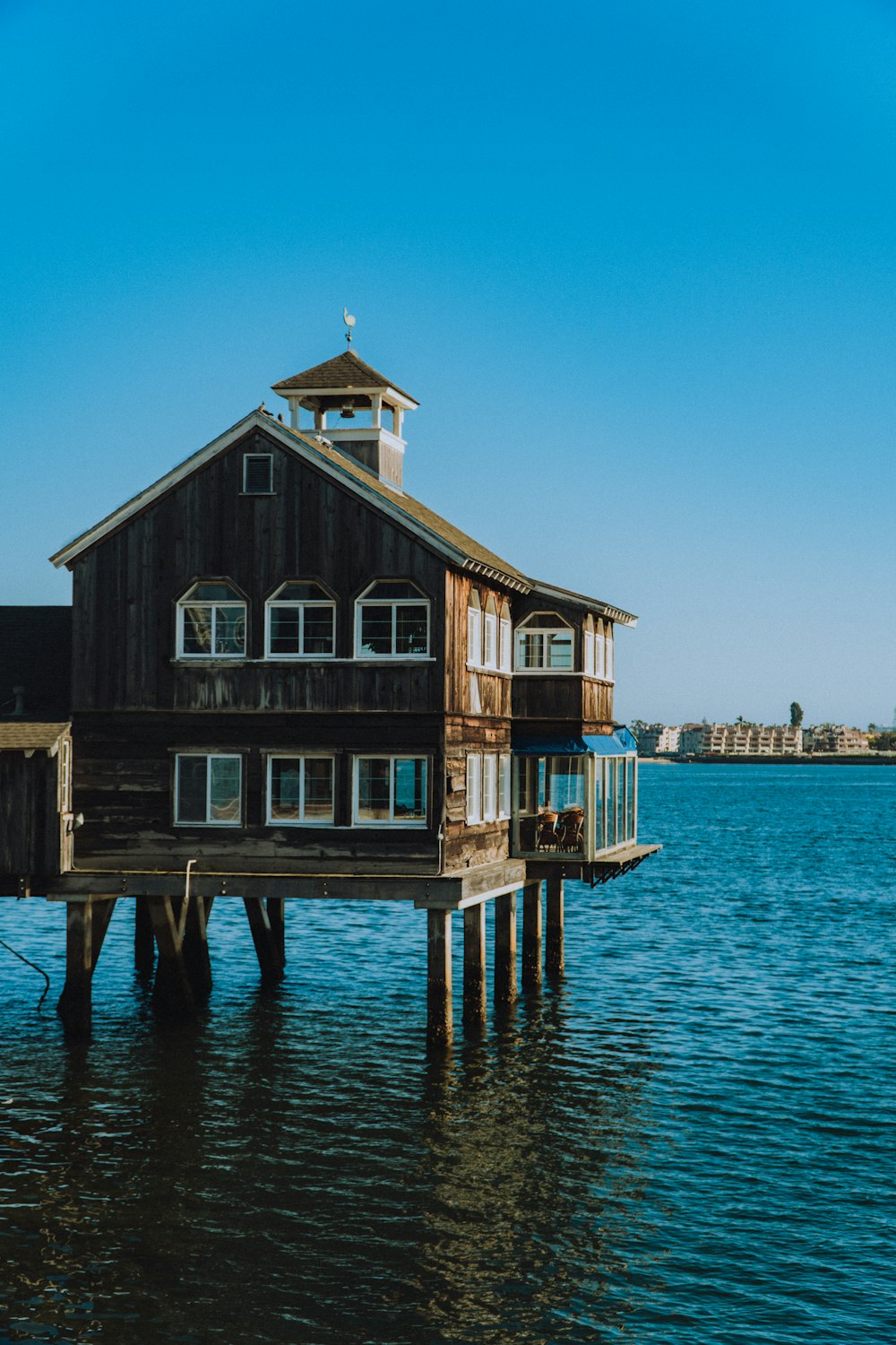 brown wooden house on dock during daytime