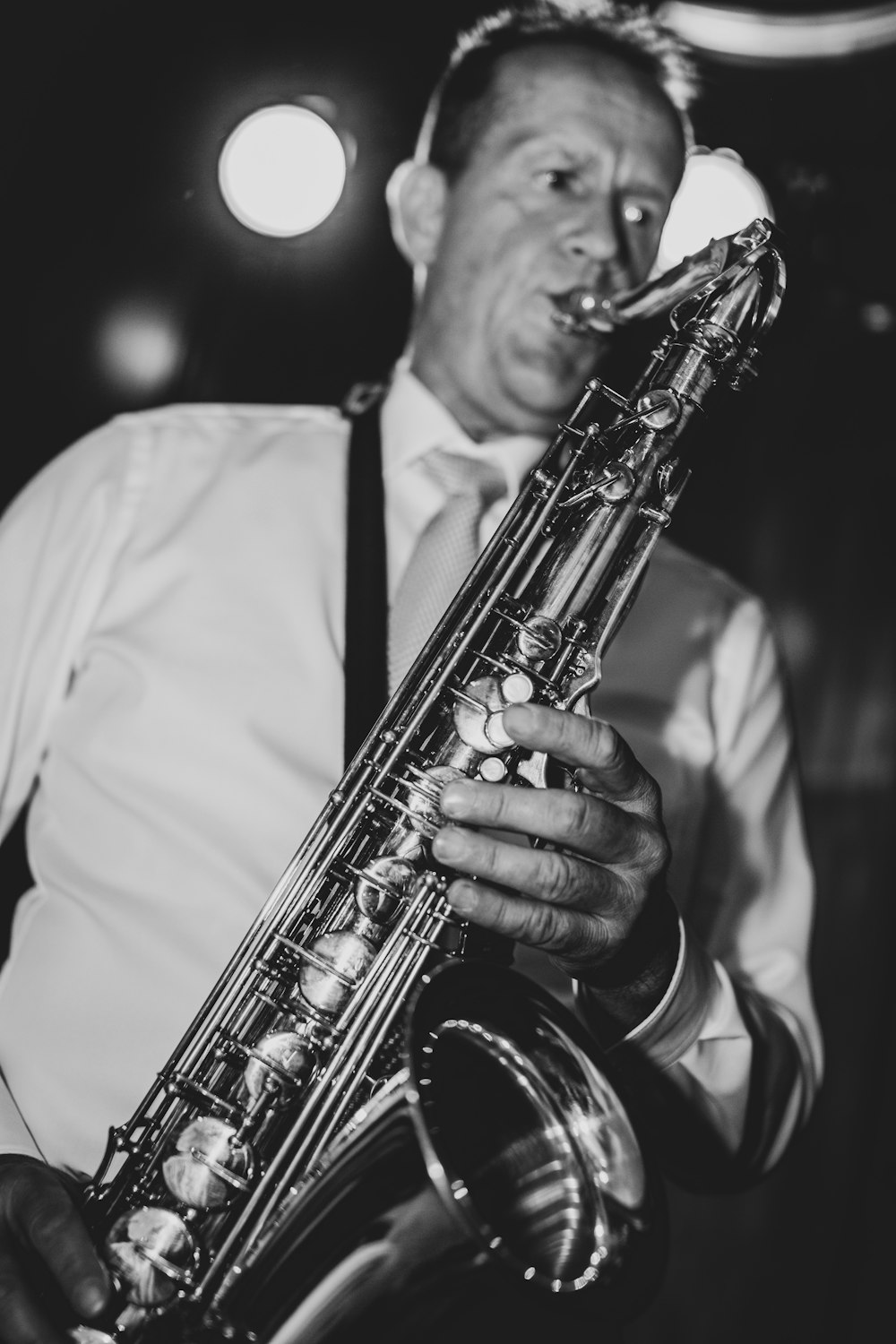 man in white dress shirt playing trumpet