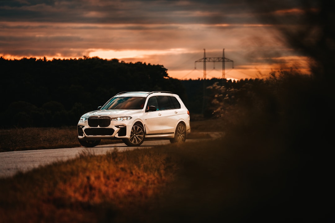 white suv on brown field during sunset