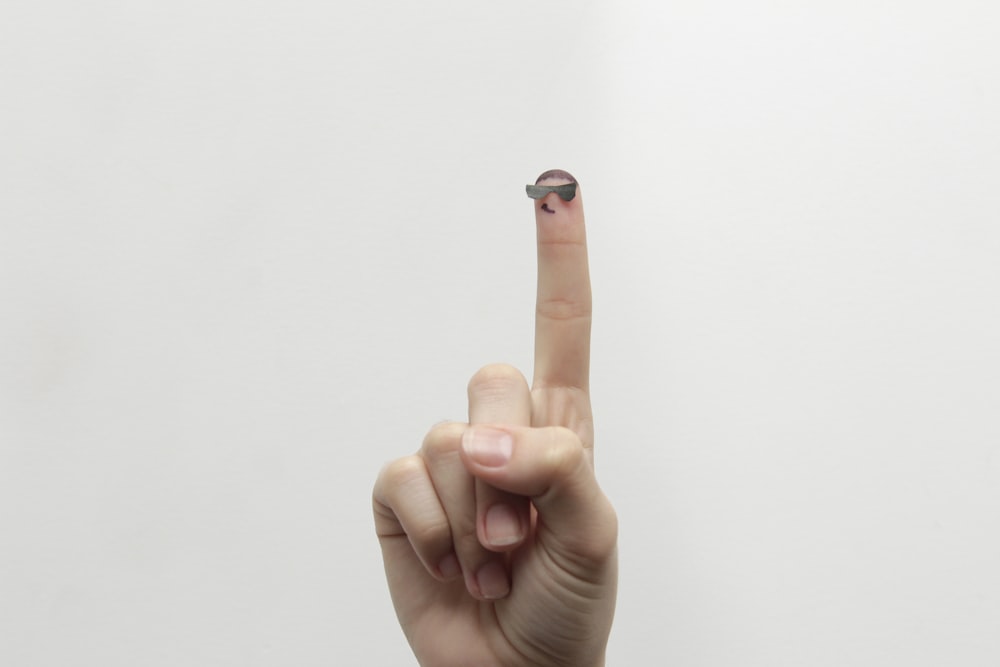 person showing right middle finger