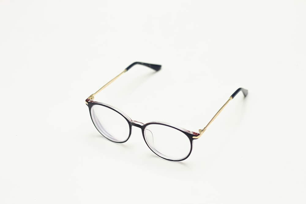 brown framed eyeglasses on white surface