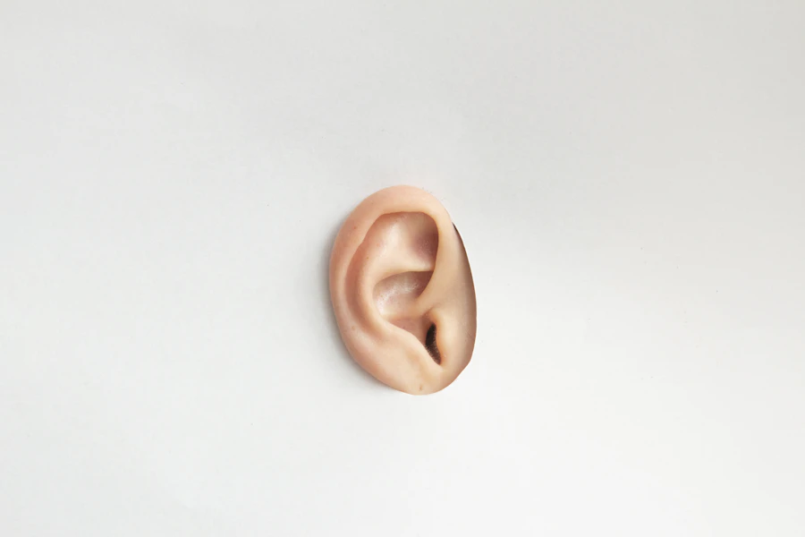 Person experiencing tinnitus holding their ear