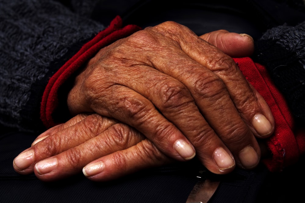 persons left hand on black textile