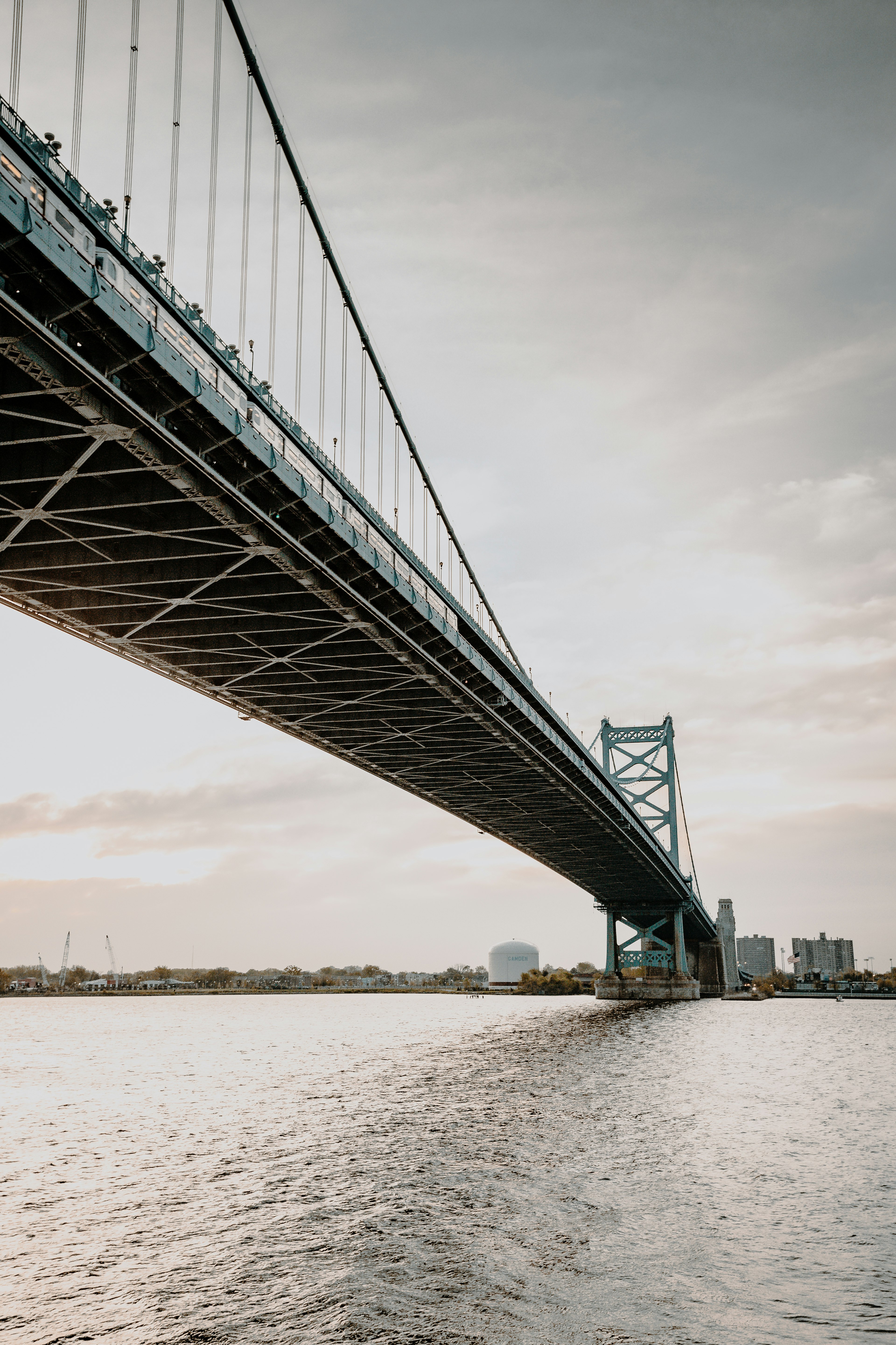 gray metal bridge over body of water during daytime