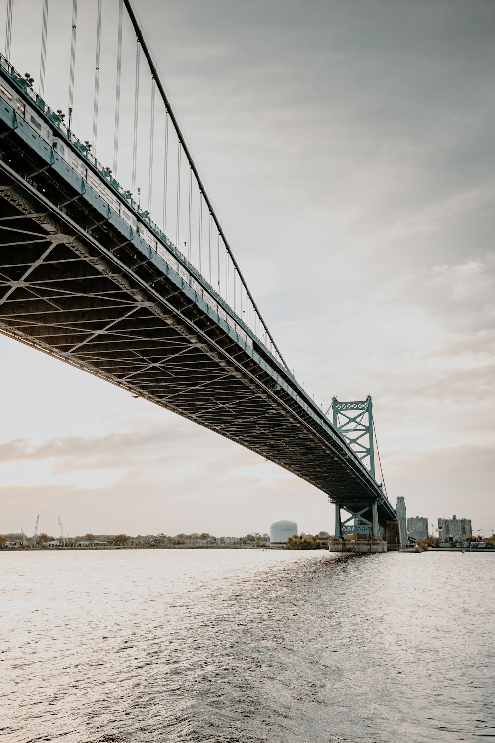 gray metal bridge over body of water during daytime