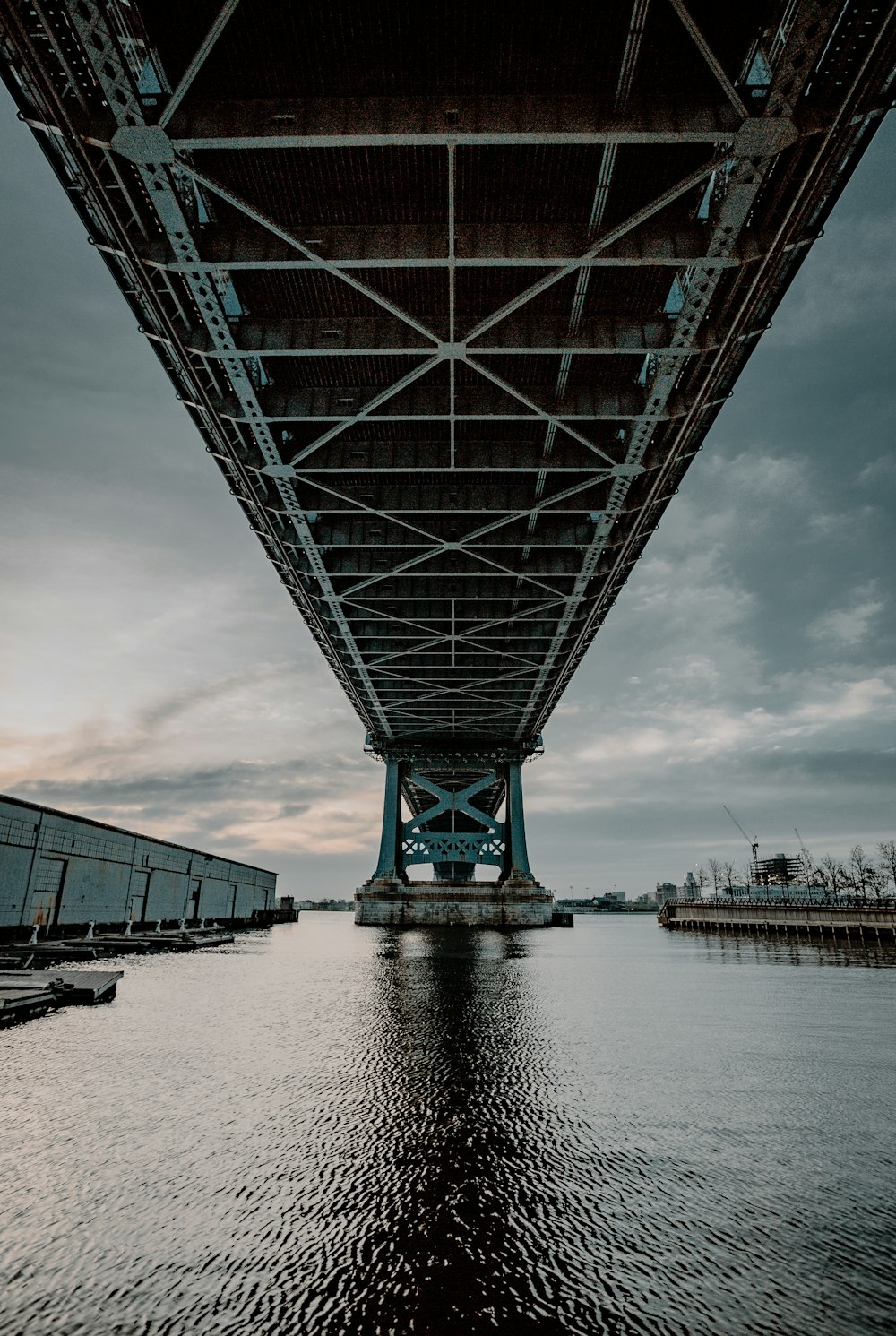 gray metal bridge under gray sky