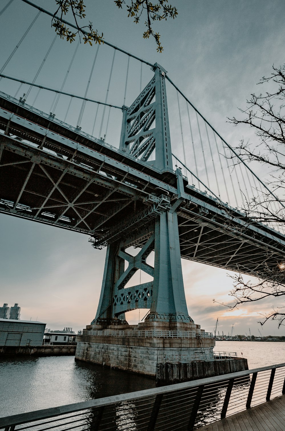 gray bridge under cloudy sky during daytime