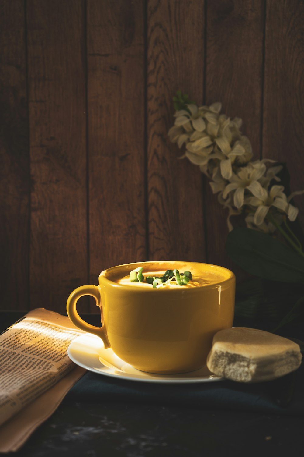 yellow ceramic mug on white ceramic saucer