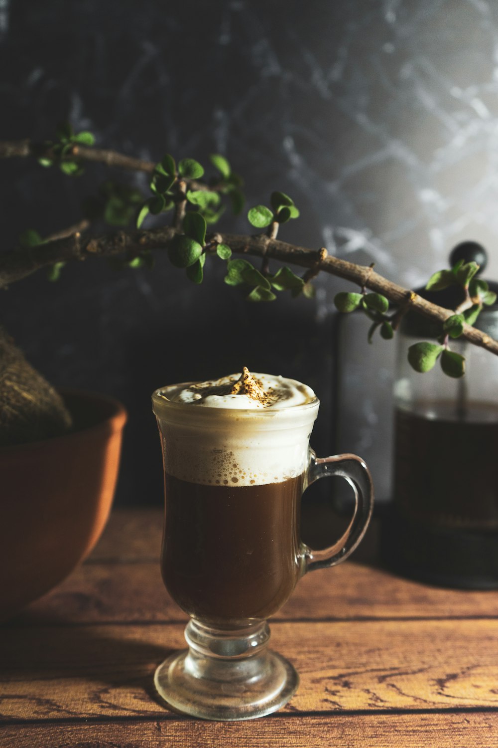 clear glass mug with brown liquid inside