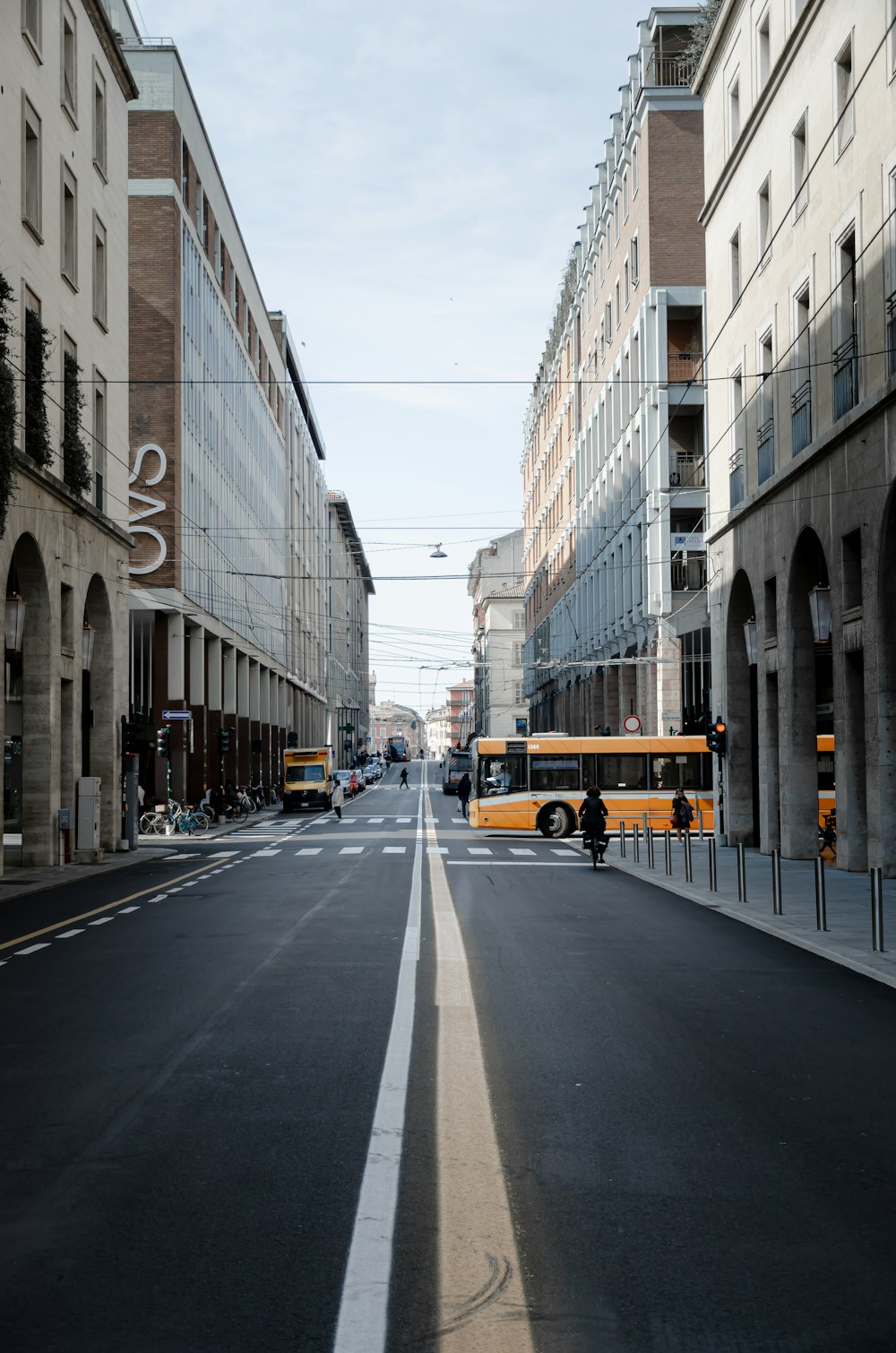 yellow bus on road near building during daytime