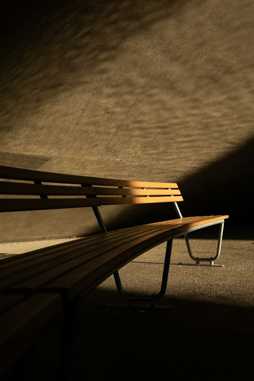 brown wooden bench on gray concrete floor