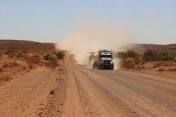 brown truck on dirt road during daytime