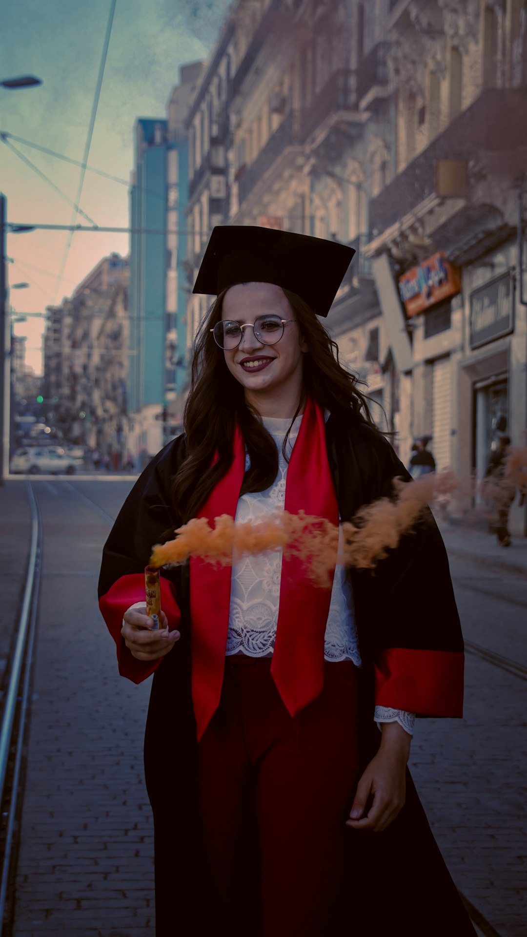 woman in academic dress holding bread