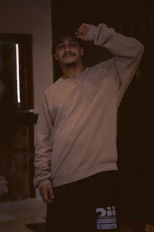 Lifestyle photo of a person wearing Timetraps apparel in a cozy indoor setting.