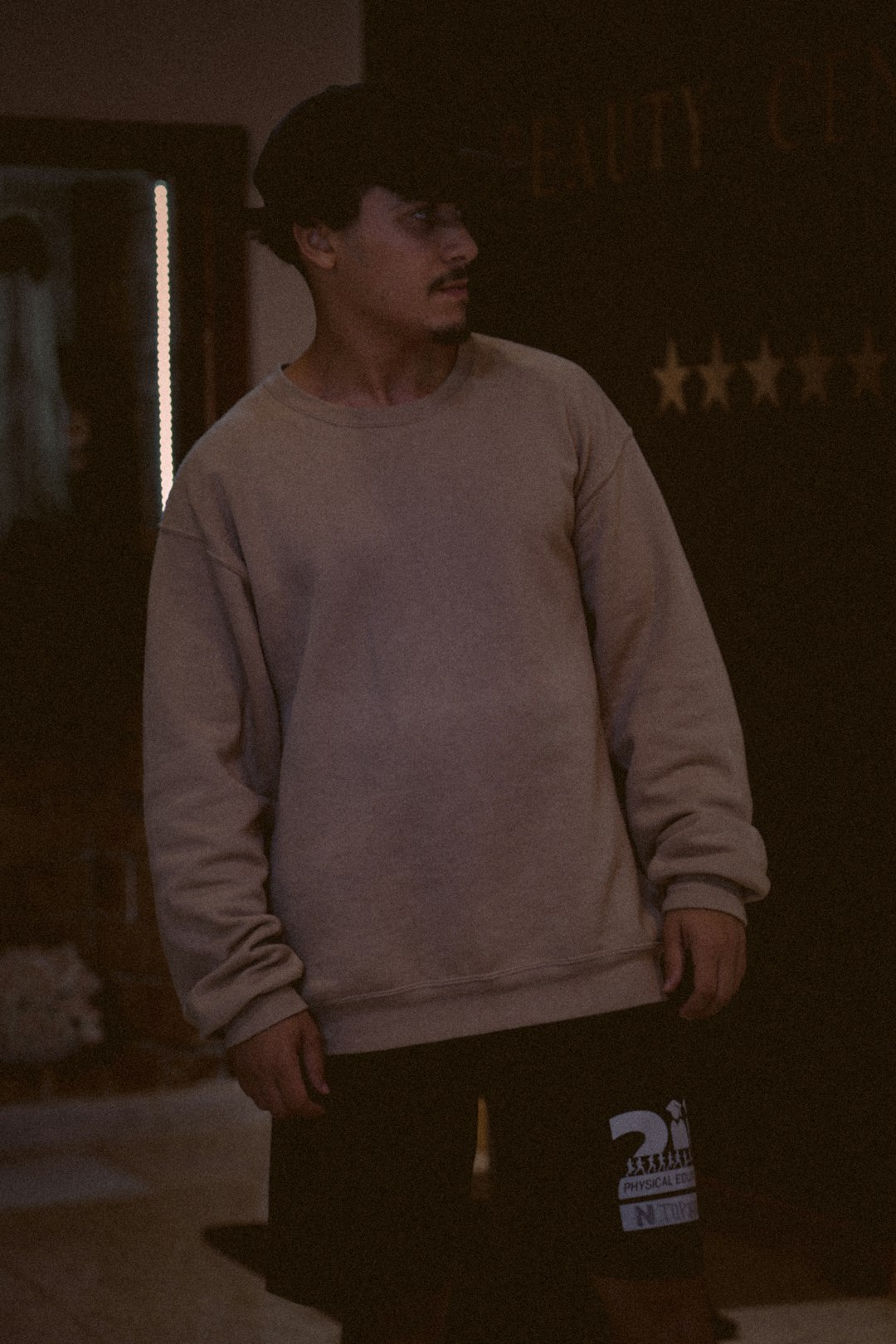 man in gray sweater standing