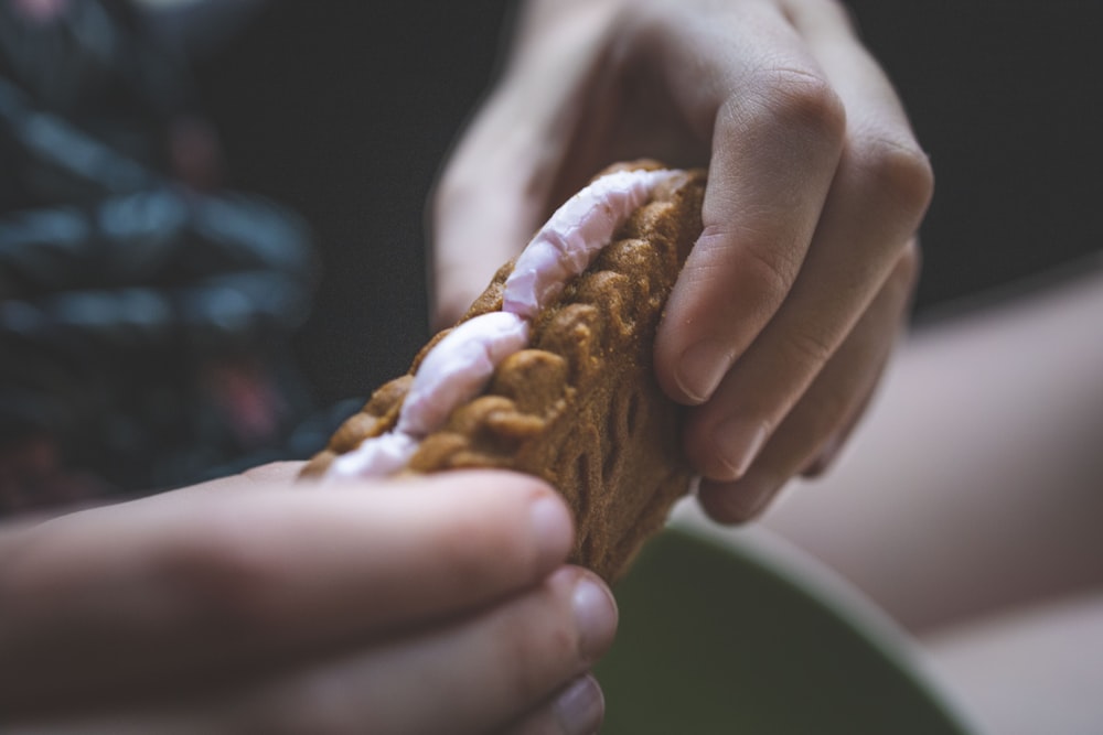 person holding brown bread with chocolate