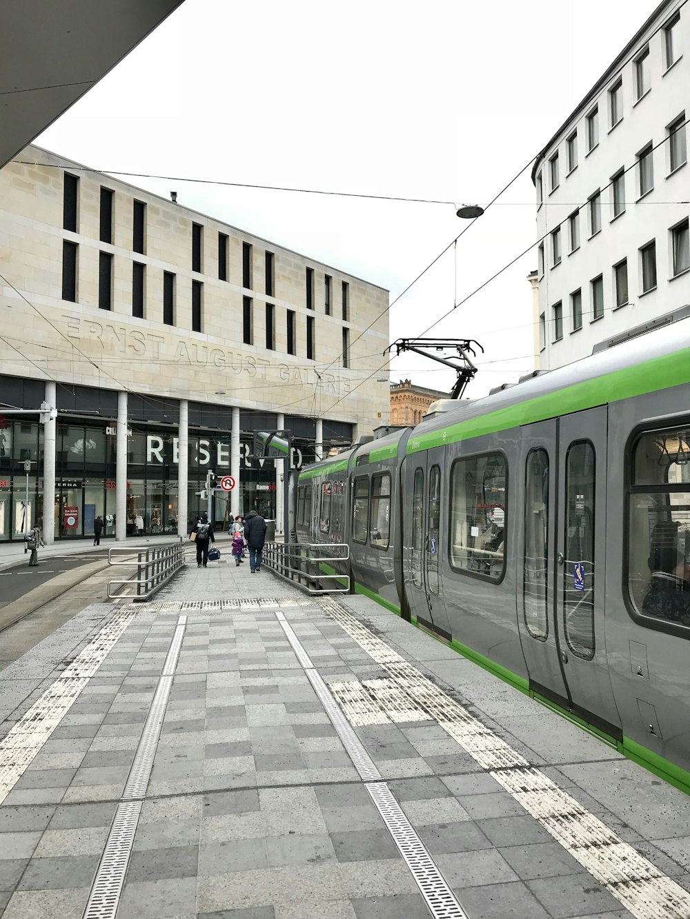 green and white train on rail road during daytime