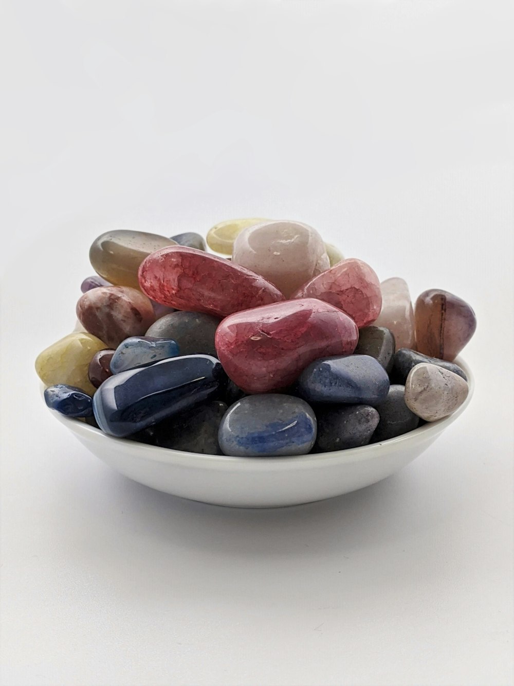 white blue and brown ceramic bowl with brown and beige stones