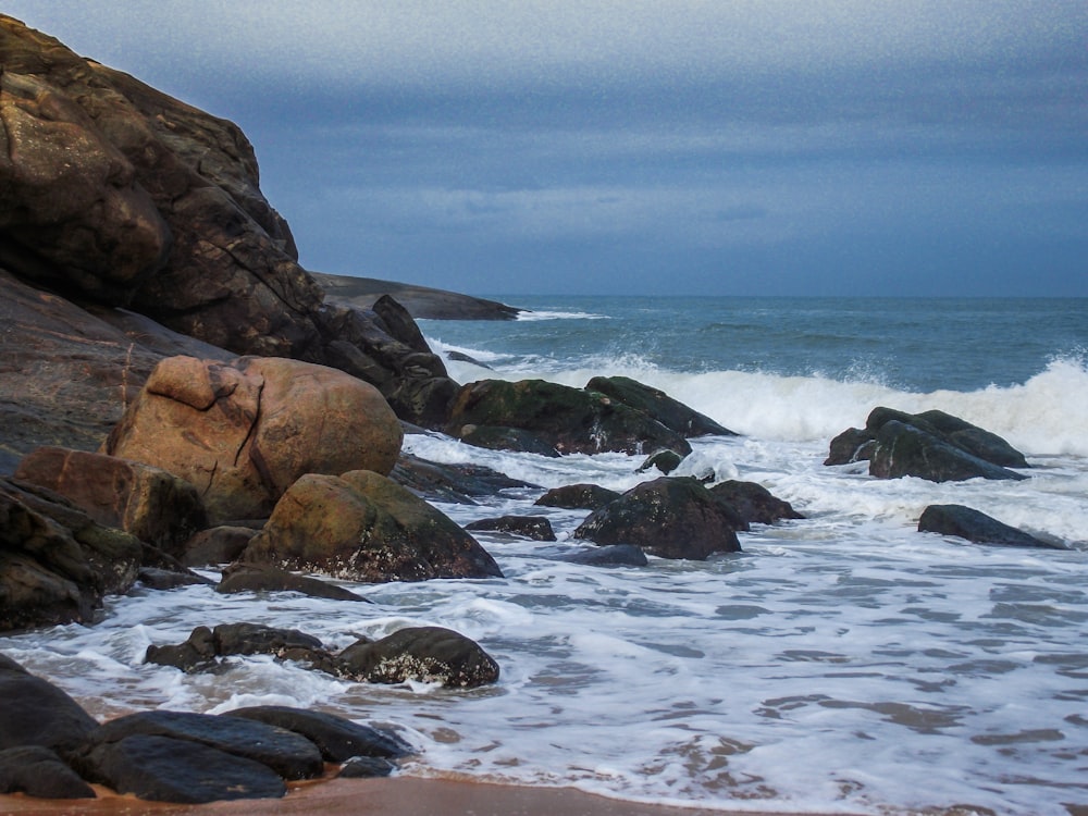 brown rock formation on sea during daytime