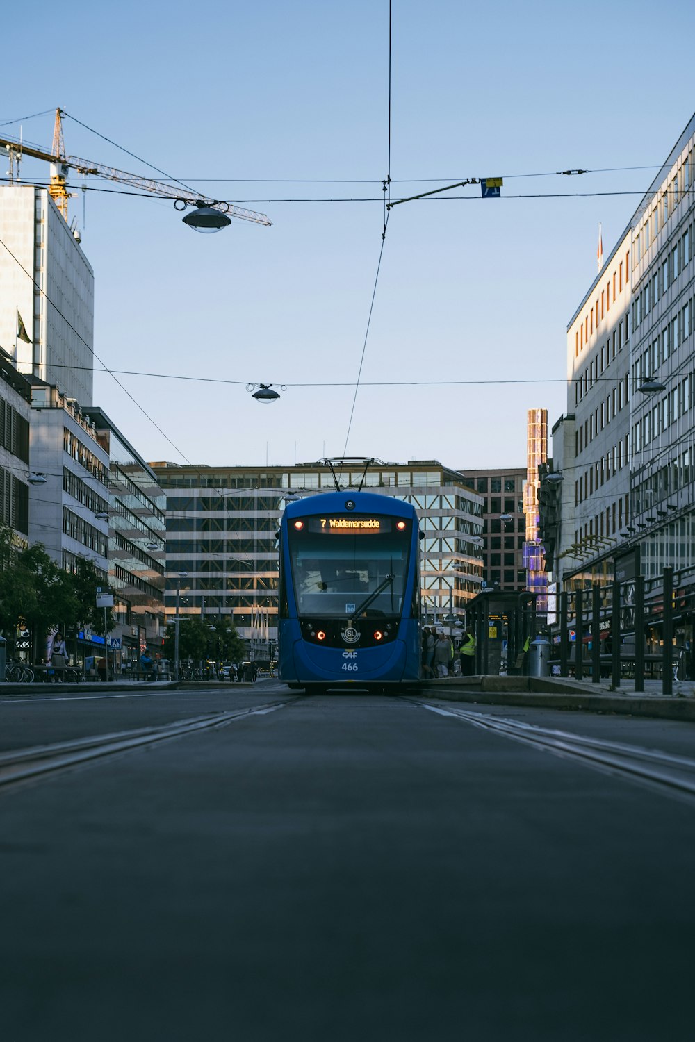 blue and yellow tram on road during daytime