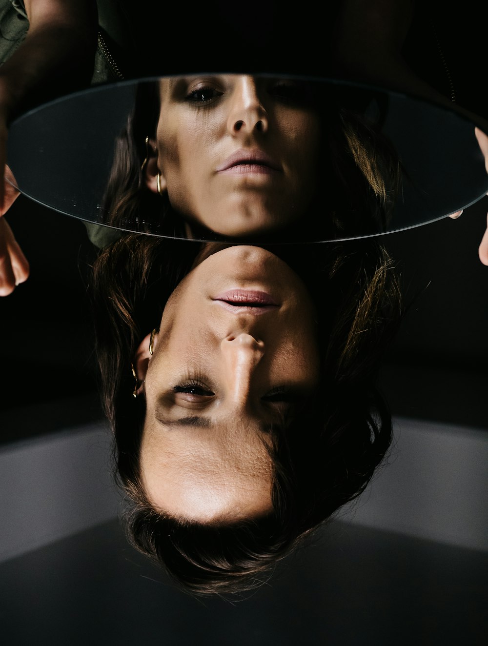 woman in black shirt with silver hoop earrings