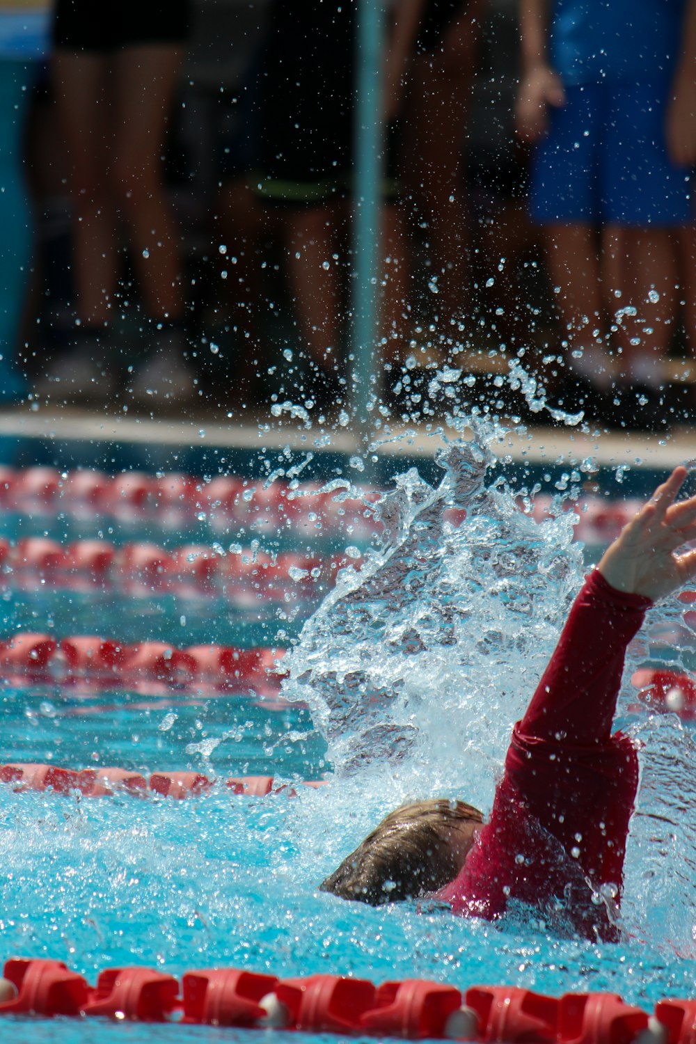 person in red pants in water