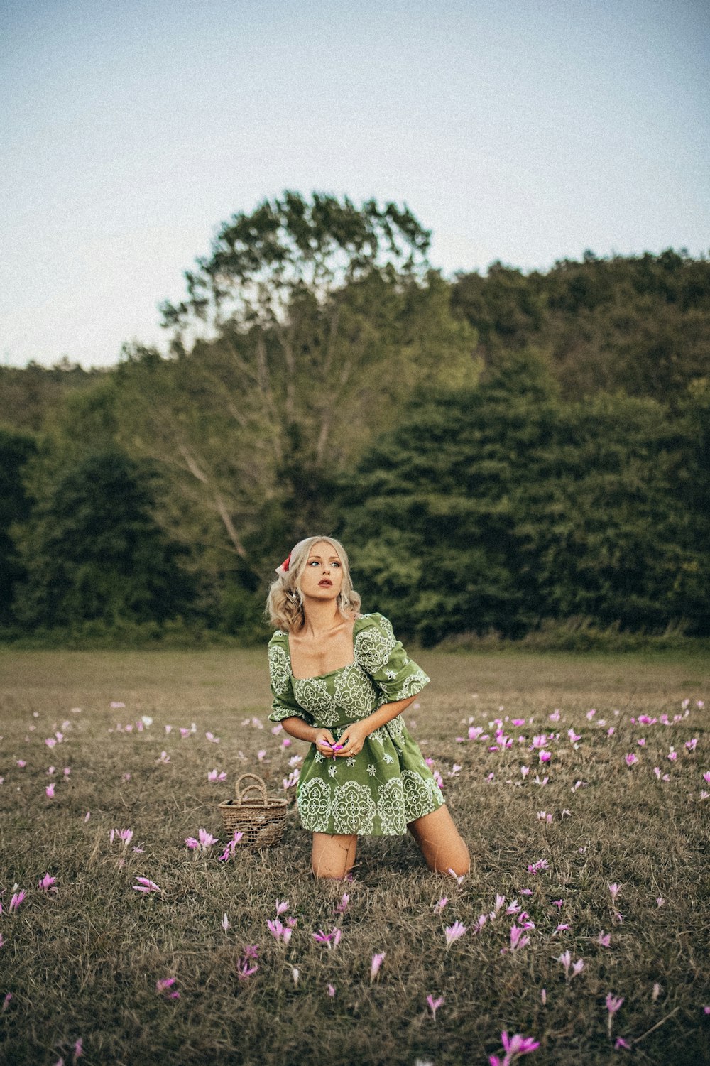 girl in green dress standing on purple flower field during daytime