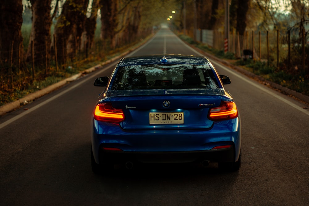 blue honda car on road during daytime