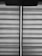Horizontal blinds with a fabric texture are partially drawn, allowing a vertical sliver of light to pass through. A pull cord hangs from the upper portion of the blinds.