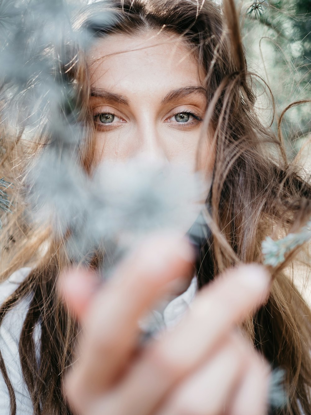 woman holding white dandelion flower