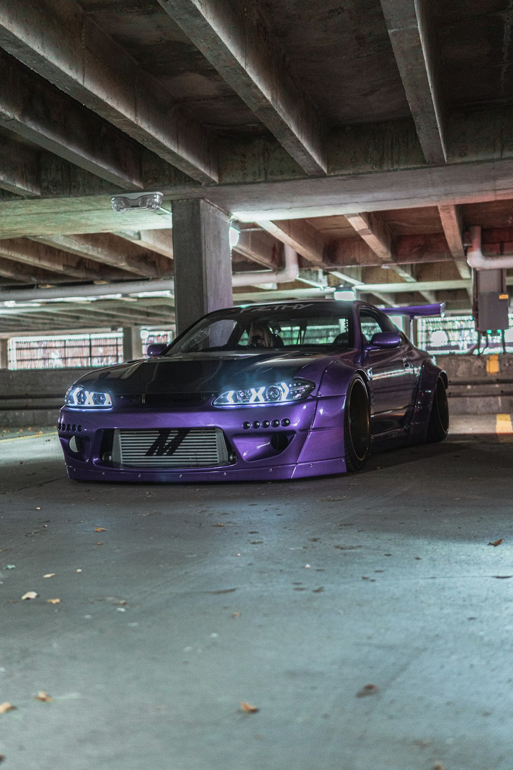 purple porsche 911 parked in garage