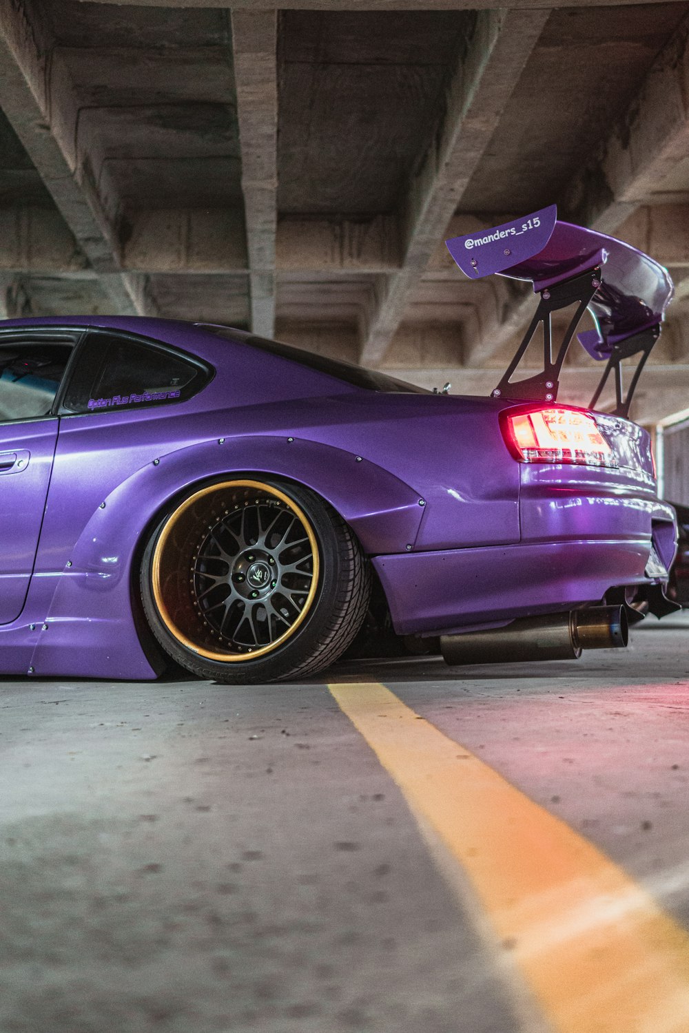 purple porsche 911 parked near brown wooden wall