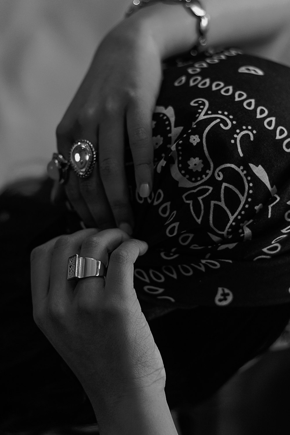 grayscale photo of person wearing ring