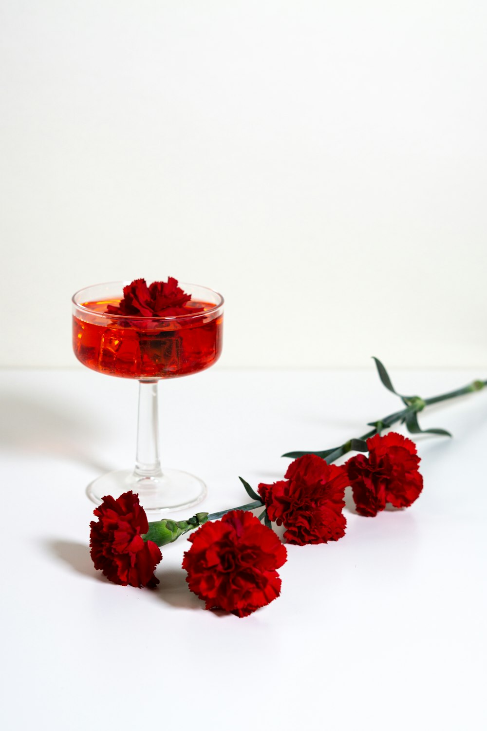 red rose on clear glass wine glass