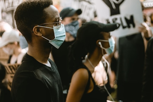 man in black crew neck shirt wearing sunglasses