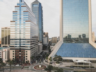 cars on road near high rise buildings during daytime
