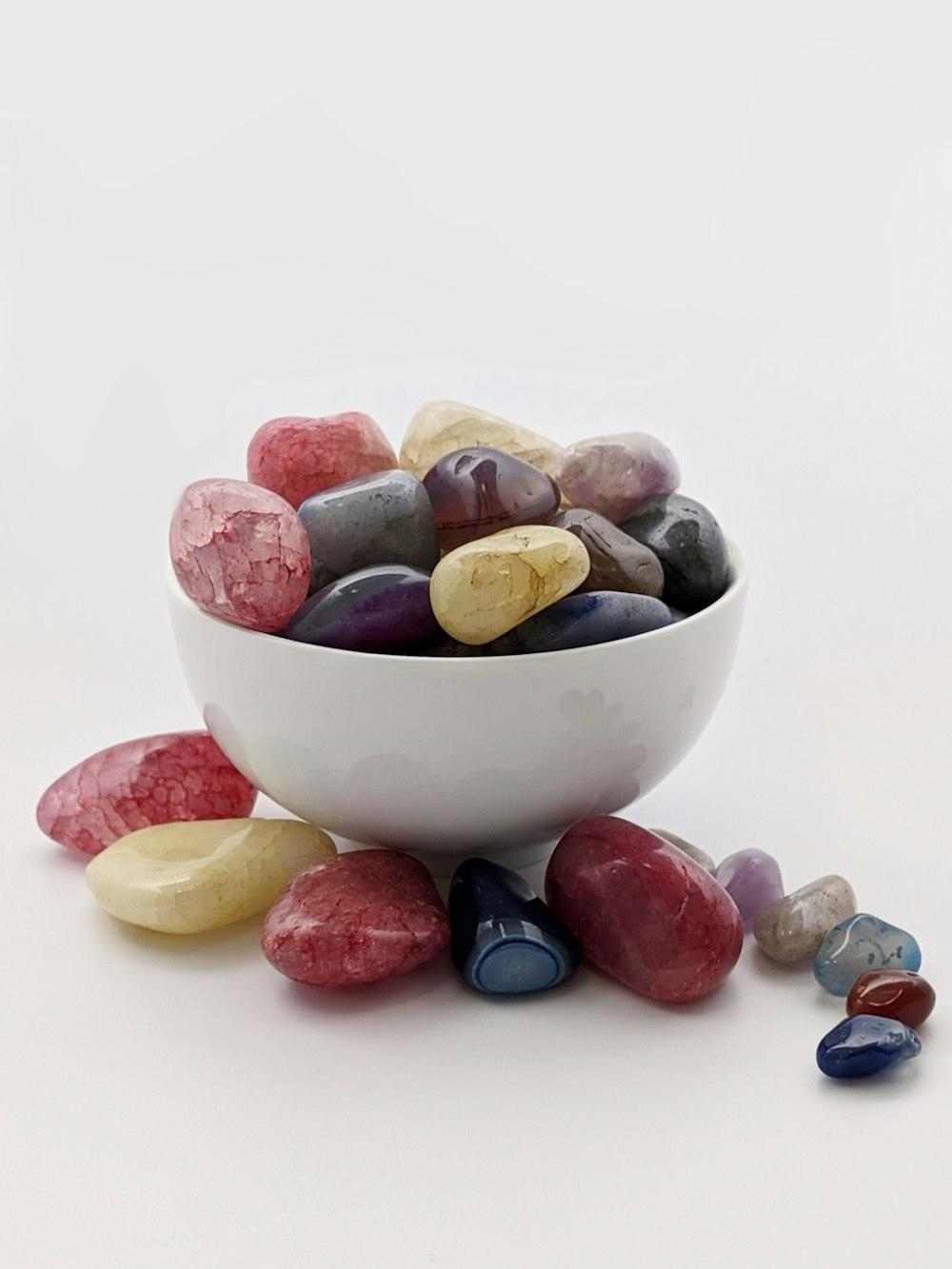white ceramic bowl with brown and pink stones
