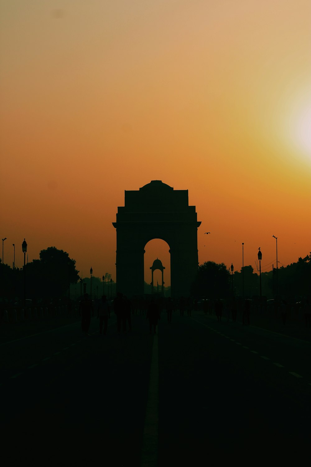 silhouette of people walking on park during sunset