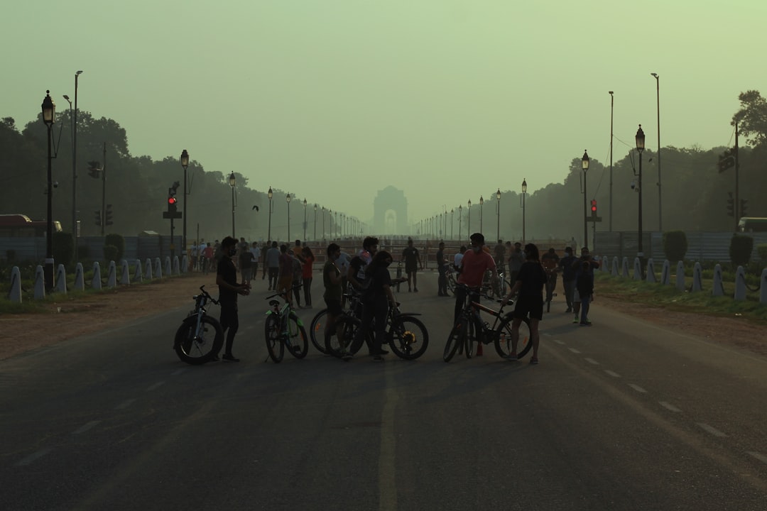 people riding bicycles on road during daytime