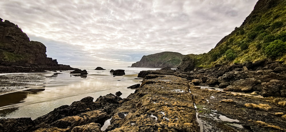 a rocky beach with a body of water