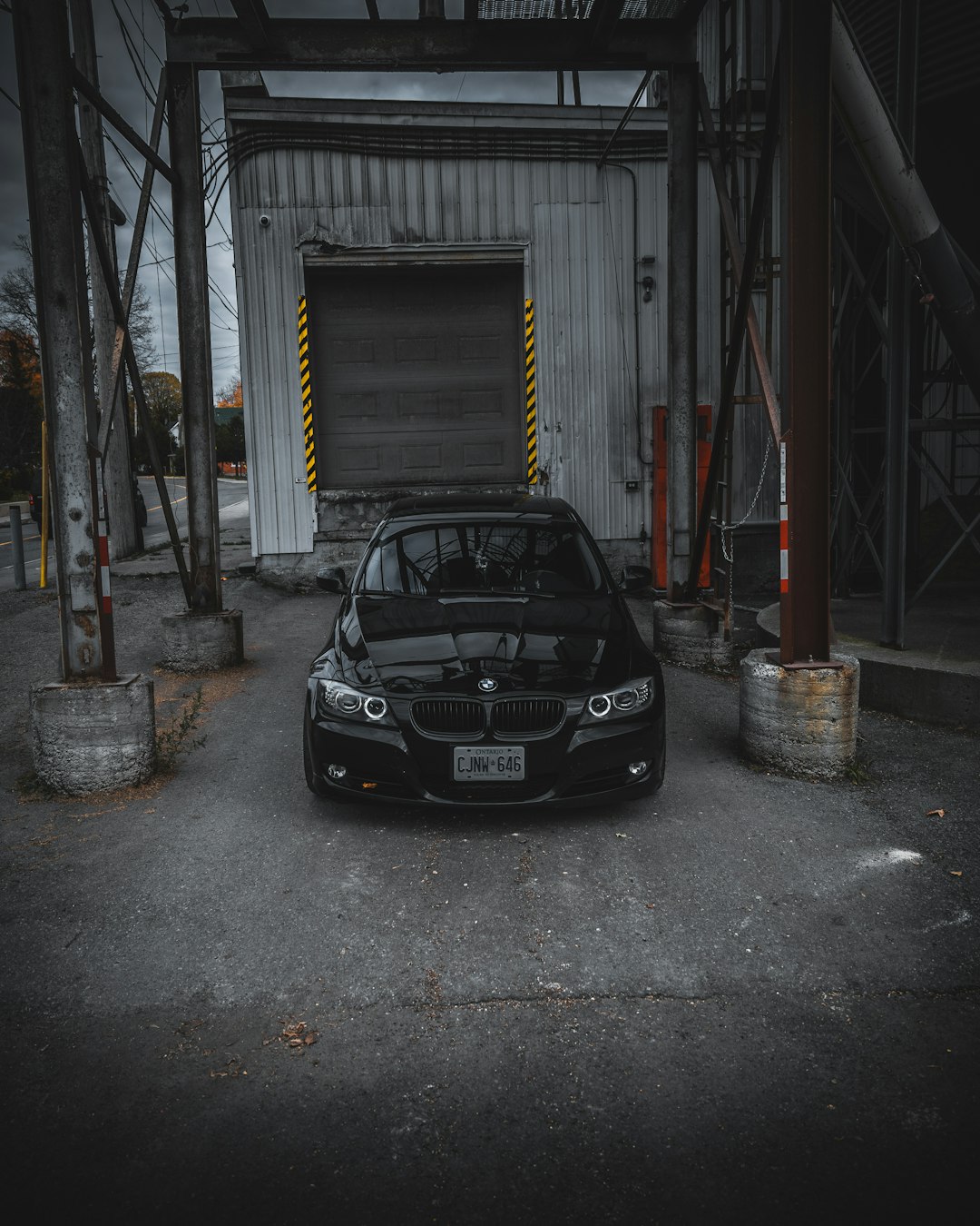 black car parked in front of white building