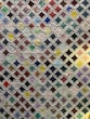 a close up of a quilt with many different colors