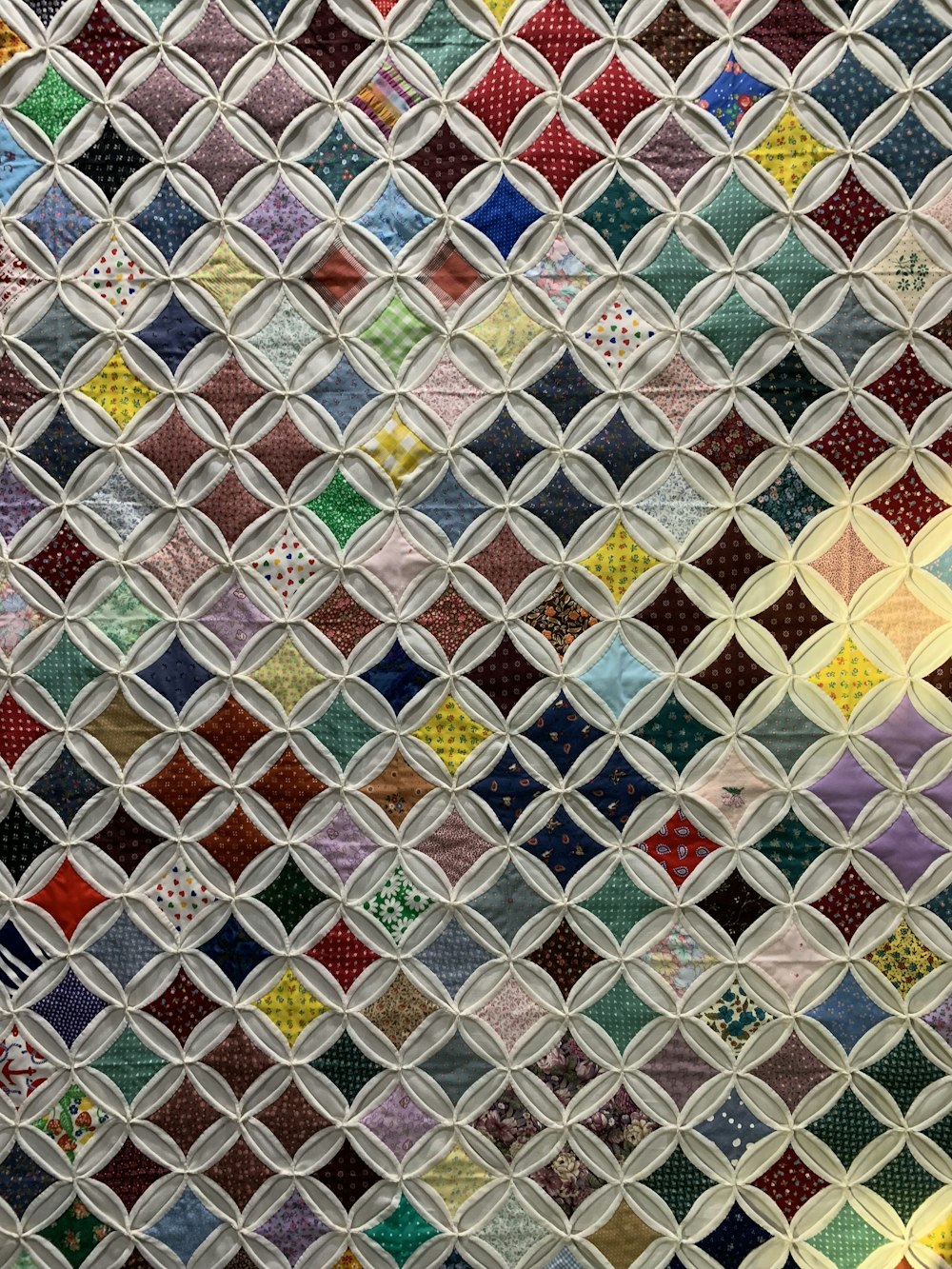 a close up of a quilt with many different colors