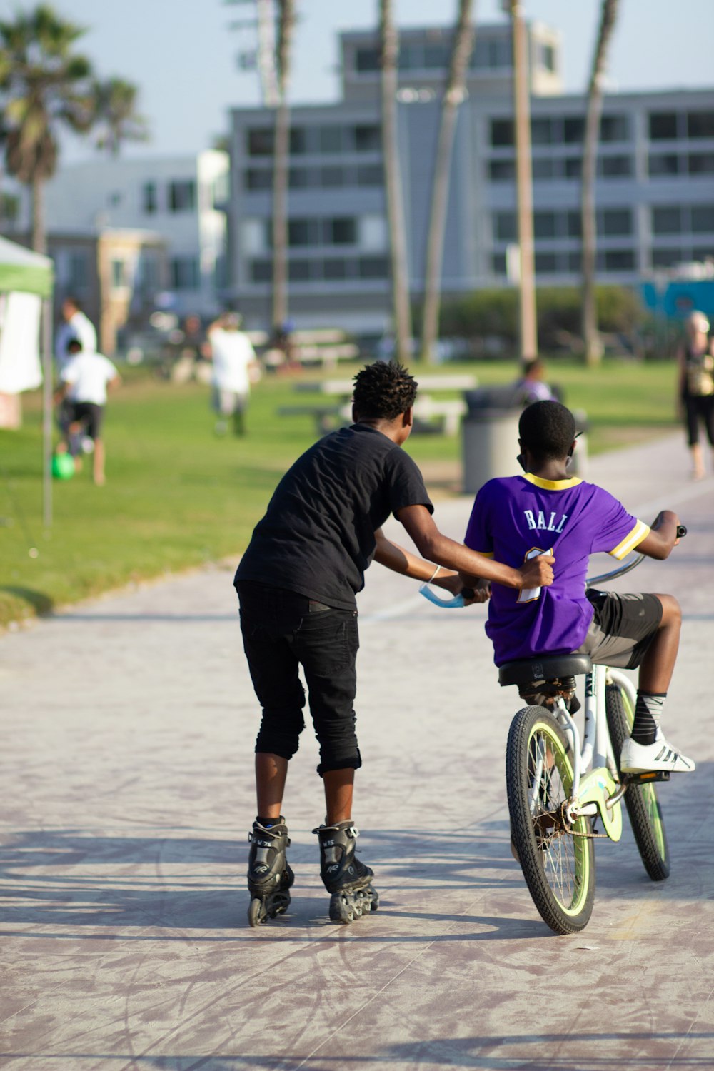 man in blue t-shirt and black pants riding bicycle during daytime