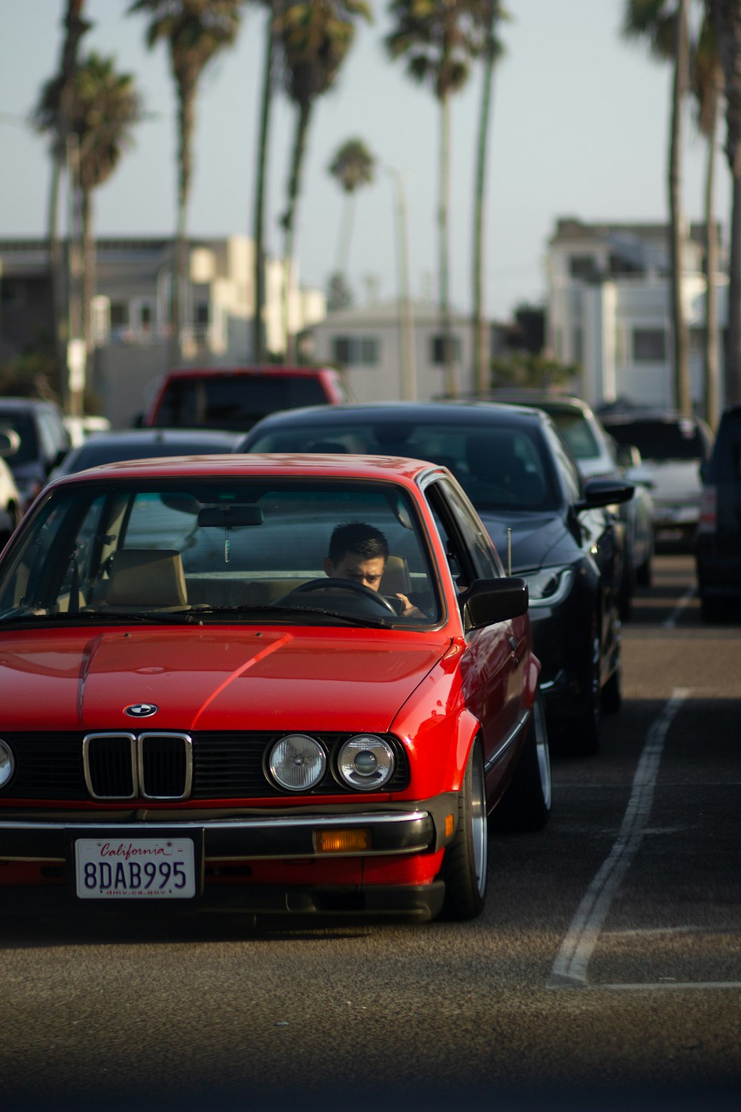 red bmw m 3 parked on parking lot during daytime