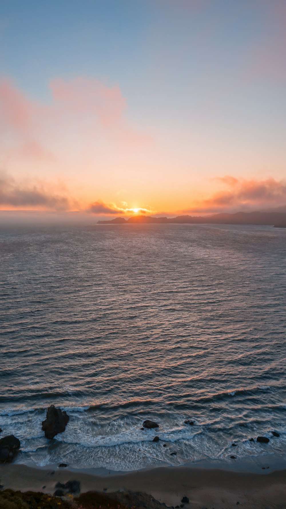 body of water during sunset