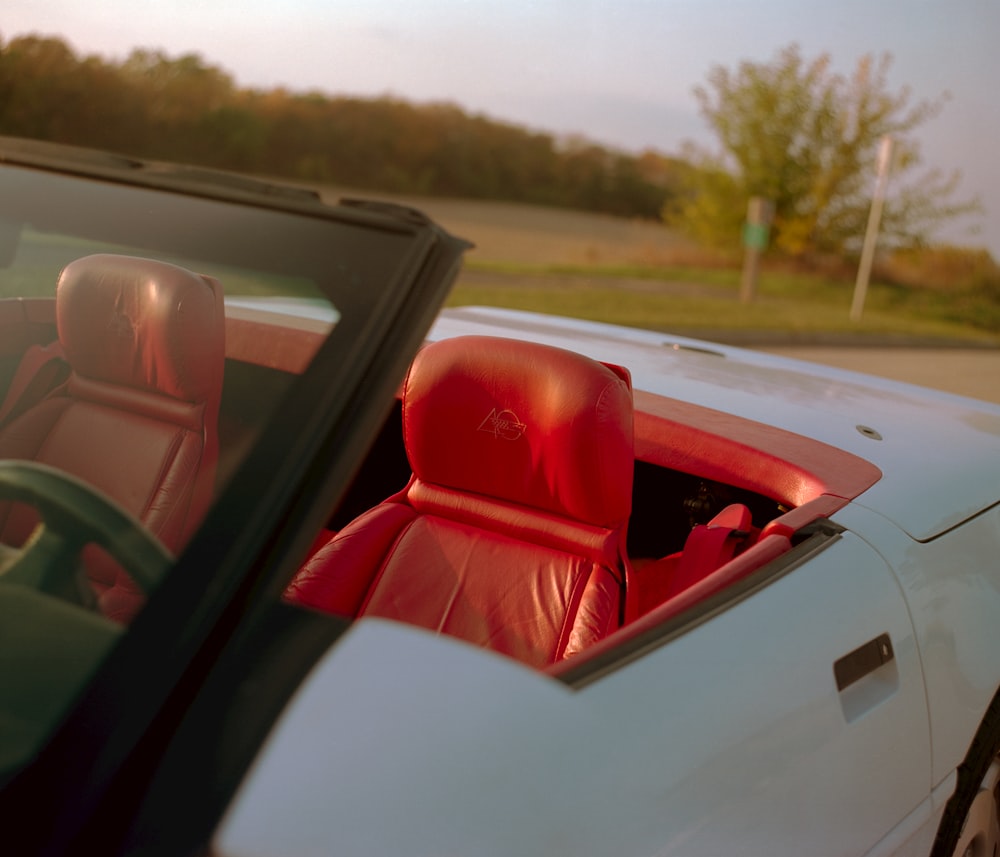 red convertible car on road during daytime