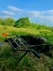 A serene outdoor scene of a person unloading old gym equipment from a vehicle.