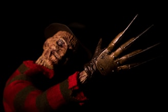 person in brown and red gloves